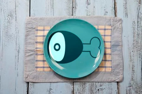 Empty plate with meat icon on light blue wooden background Stock Photos