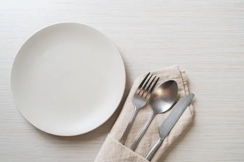 Empty plate or dish with knife, fork and spoon Stock Photos