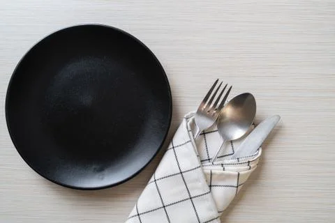 Empty plate or dish with knife, fork and spoon Stock Photos