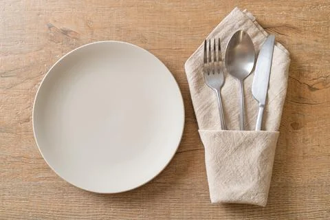 Empty plate or dish with knife, fork and spoon Stock Photos