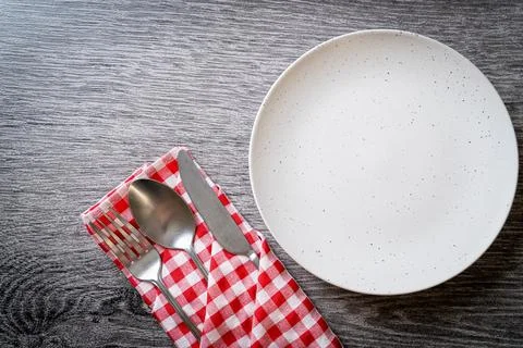 Empty plate or dish with knife, fork and spoon Stock Photos