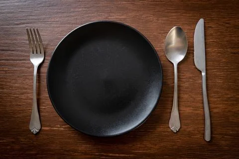 Empty plate or dish with knife, fork and spoon Stock Photos