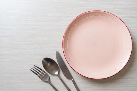 Empty plate or dish with knife, fork and spoon Stock Photos