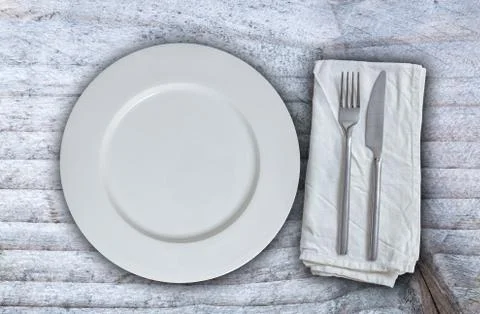 Empty plate with silverware on gray background 스톡 사진
