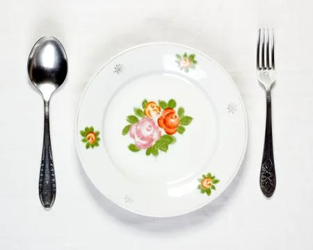 Empty plate with spoon and fork Stock Photos