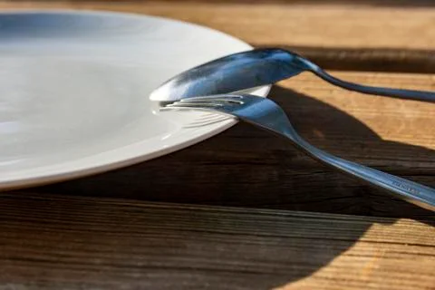 Empty plate with spoon and fork Stock Photos