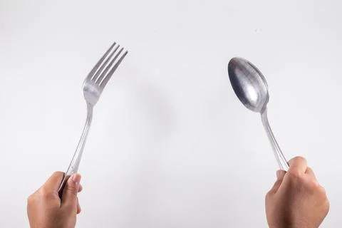 A empty plate with spoon and fork isolated on white background Stock Photos