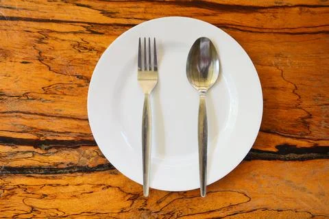 Empty plate with spoon fork on food table wooden background - empty dinner .. Stock Photos