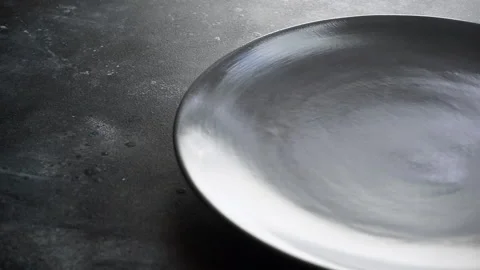 Empty plate on the table. Empty gray dinner plate and fork set on a table in  Stock Footage 137784138