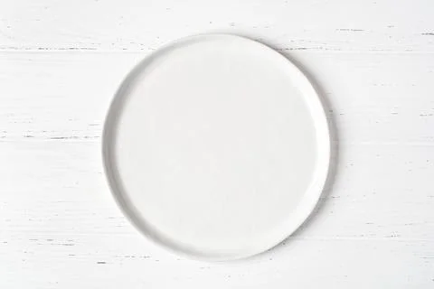 An empty plate on a white table. Stock Photos