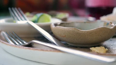 Empty plates and bowl after a meal on a table Stock Footage 314691674