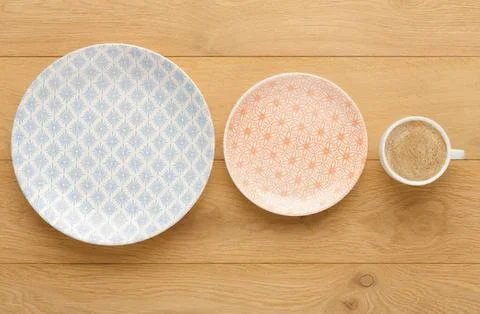 Empty plates and coffee mug on wooden table Stock Photos