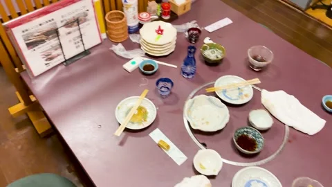 Empty Plates and Leftovers on a Traditional Japanese Izakaya Dining Table Stock Footage 331776934