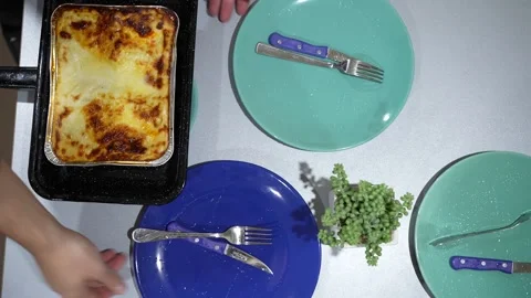 Empty plates and a tray of lasagne on the table Stock Footage 228571308