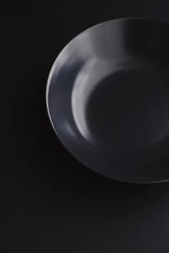 Empty plates on black background, premium dishware for holiday dinner Stock Photos