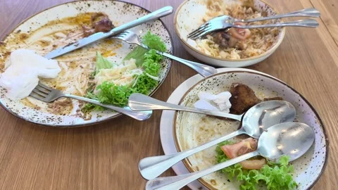 Empty Plates with Food Leftovers on a Dining Table Stock Footage 338427136