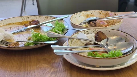 Empty Plates with Food Leftovers on a Dining Table Stock Footage 338427218