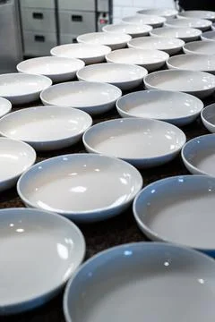 Empty plates in a restaurant kitchen. Stock Photos