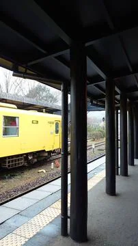 An empty platform in JR Yufuin Station with a train stopping in the opposite Stock Photos