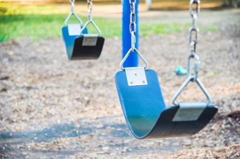 Empty playground blue swing set (selective focus) Stock Photos