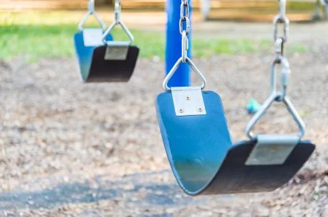 Empty playground blue swing set (selective focus) Stock Photos