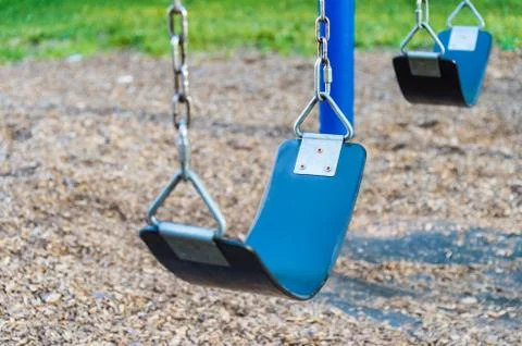 Empty playground blue swing set (selective focus) Stock Photos