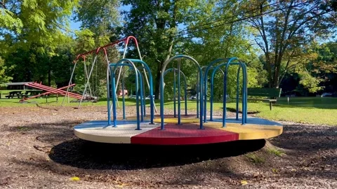 Empty Playground Carousel Spinning At Park On Sunny Day Vídeo Stock 346304720