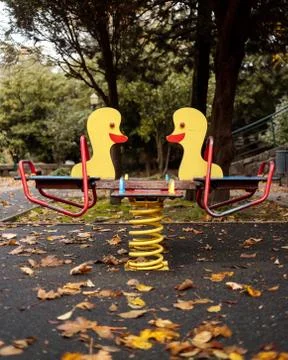 Empty playground duck swing on a fall day Stock Photos