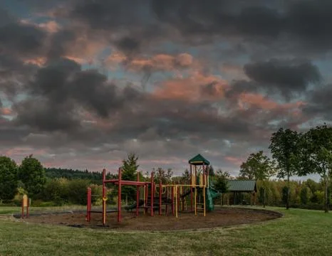 Empty playground in the evening as a storm approaches. Stock Photos