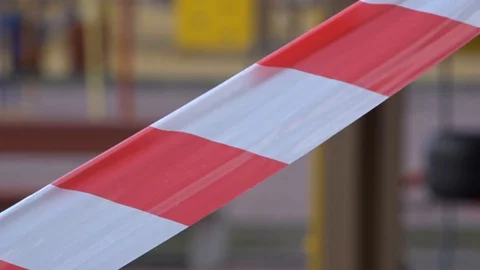 An empty playground fenced off with warning tape. Quarantine Concept. Child Stock Footage 128079581
