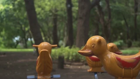 Empty playground, moving merry go round with duck shaped seats. Stock Footage 233883258