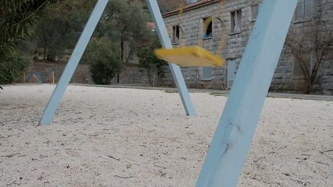 Empty playground with moving swig in winter in Europe Stock Footage 75253331