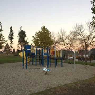 Empty playground at sunset Stock Photos