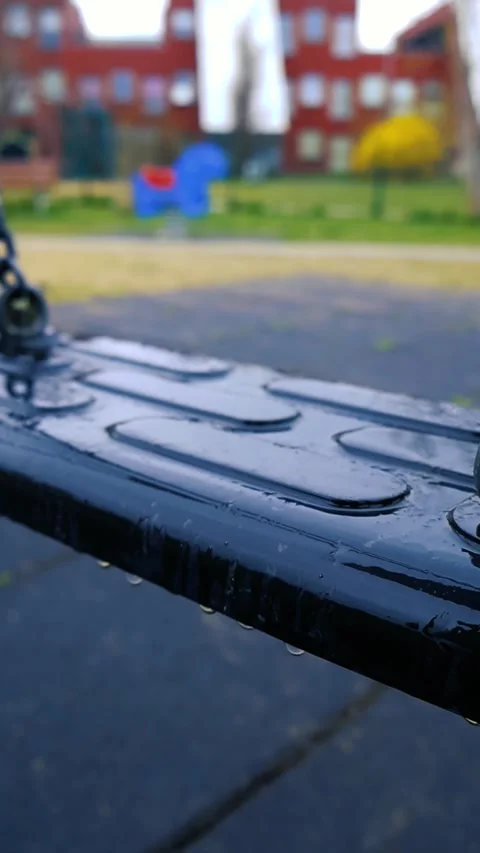 Empty Playground Swing on a Rainy Day, Bokeh Background Stock Footage 335133765