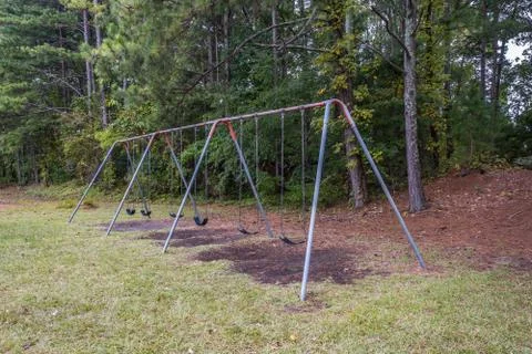 Empty playground swing set at the park Stock Photos