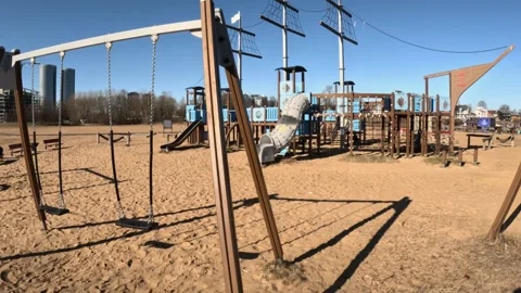 Empty playground with swings and ship shaped slide in Kipsala, Riga Stock Footage 307945524