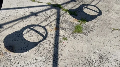 Empty Playground Swings Casting Long Shadows on Sunny Day Stock Footage 346489412