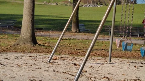 Empty Playground with Swings Gently Blowing in the Wind SLOW MOTION Stock Footage 267701848