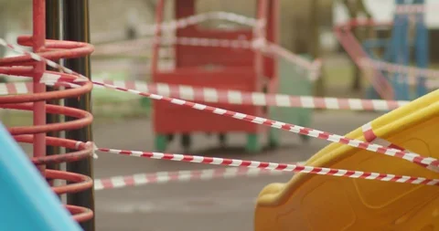 Empty playgrounds covered with a protective tape during quarantine of Stock Footage 128531121