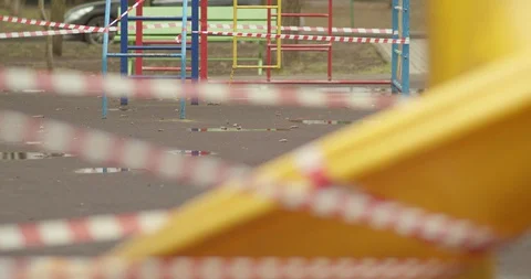 Empty playgrounds covered with a protective tape during quarantine of Stock Footage 128538063