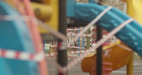 Empty playgrounds covered with a protective tape during quarantine of Stock Footage 128540382