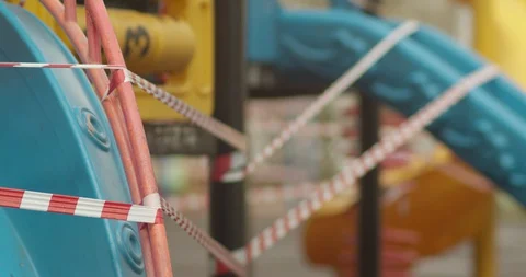 Empty playgrounds covered with a protective tape during quarantine of Stock Footage 128543476