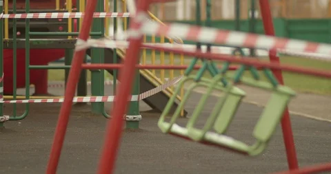 Empty playgrounds covered with a protective tape during quarantine of Stock Footage 128546791