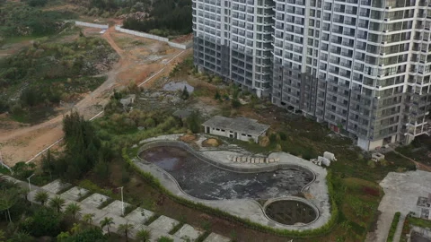 Empty Pool and Abandoned Apartment Construction Site in China Stock Footage 206904383