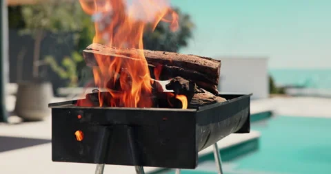 Empty, pool and bbq with fire in backyard for party, holiday and lunch on Stock Footage 324387915