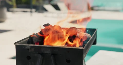 Empty, pool and bbq with flame in backyard for party, holiday and lunch on Stock Footage 325359042