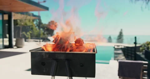 Empty, pool and bbq with flames in backyard for party, holiday and lunch on Stock Footage 325415455