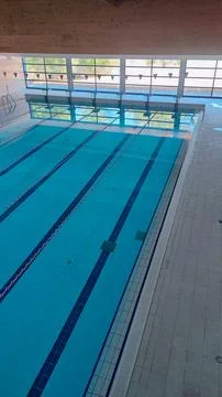 Empty Pool Renovation in a Public Pool. Sports Season Preparation Concept Stock Photos