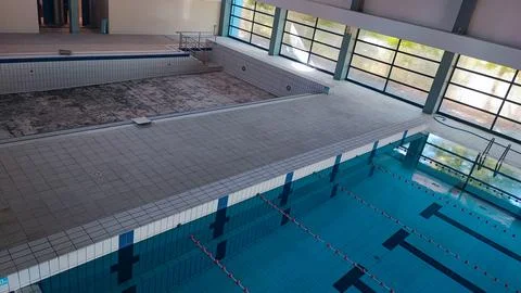 Empty Pool Renovation in a Public Pool. Sports Season Preparation Concept Stock Photos