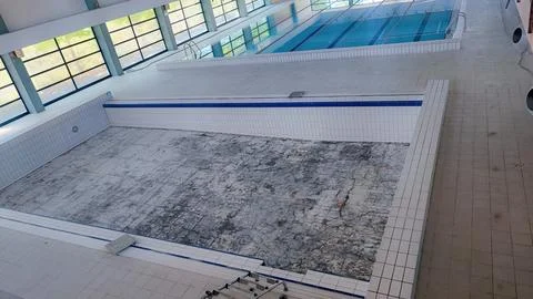 Empty Pool Renovation in a Public Pool. Sports Season Preparation Concept Stock Photos